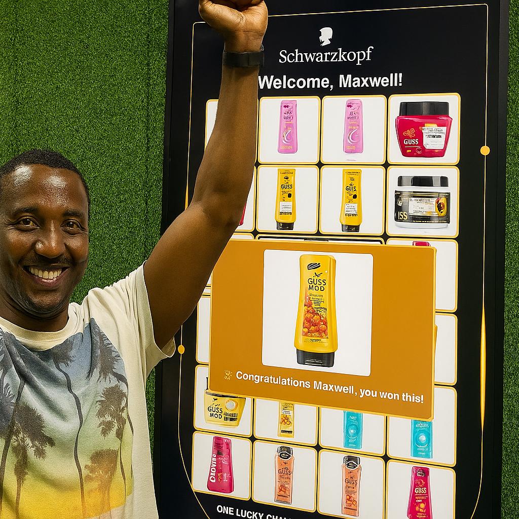 Guest playing Scan & Win interactive game by scanning QR code at a mall activation event in Dubai, with live name display and prize reveal on a big screen.